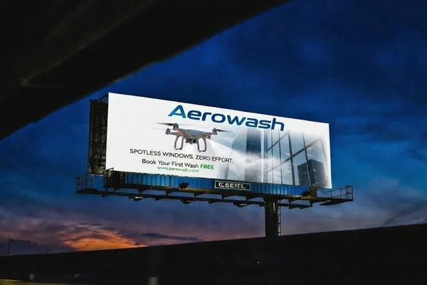 Highway billboard illuminated at twilight after professional drone cleaning