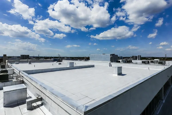 Clean white TPO membrane commercial flat roof after drone cleaning