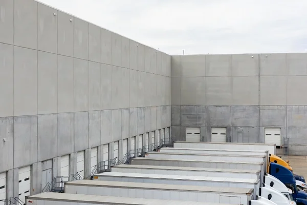 Modern distribution center with loading docks and semi-trucks